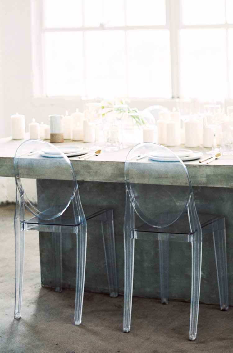 transparent chairs and a concrete table for a minimalist tablescape
