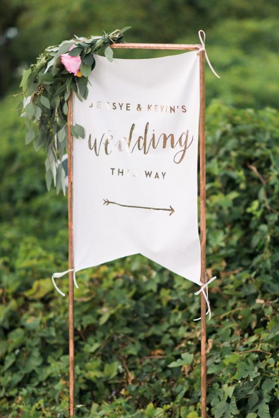 copper wedding sign decorated with flowers