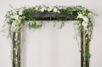 24 dark wood arbor decorated with white flowers and greenery