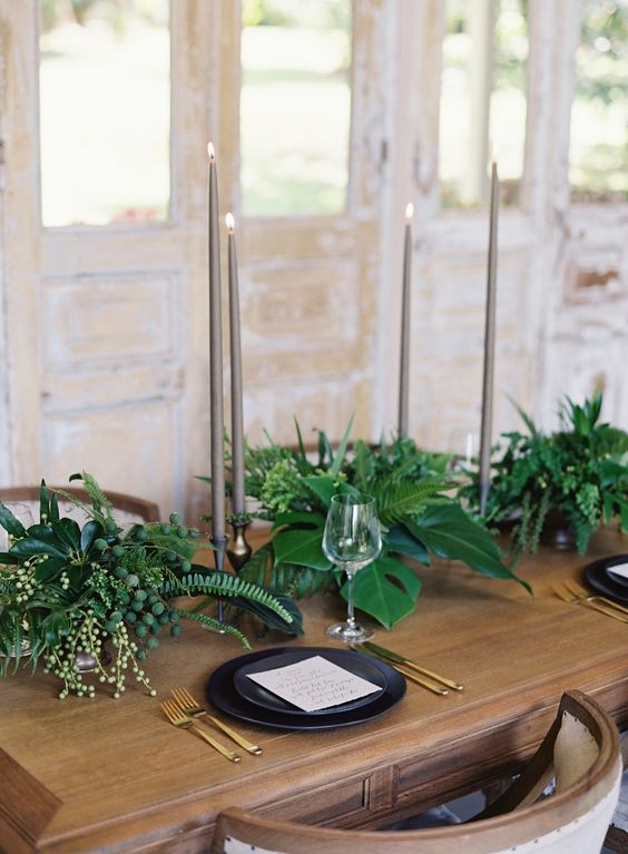 tropical minimalism with botanicals, black dishes and tall candles