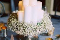 25 baby’s breath wreath surrounding pillar candles can make up a cool centerpiece