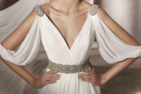 25 draped wedding gown with cutout sleeves, embellished shoulders and a belt