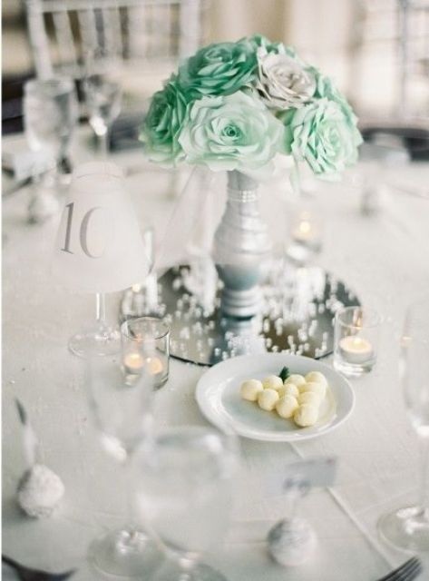 grey vase with mint paper flowers for a centerpiece