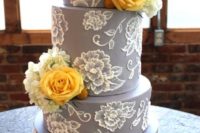 25 grey wedding cake with lacy flowers and yellow roses