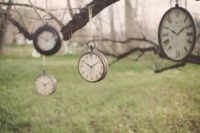 25 hanging vintage clocks from trees for outdoor decor