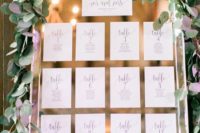 25 mirror seating chart with printed paper and eucalyptus
