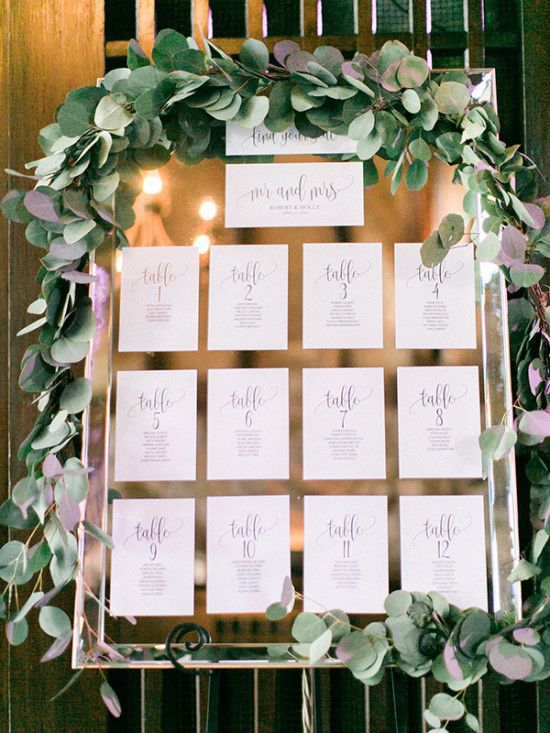 mirror seating chart with printed paper and eucalyptus