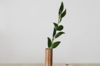 27 candles and a copper vase with leaves for a modern centerpiece