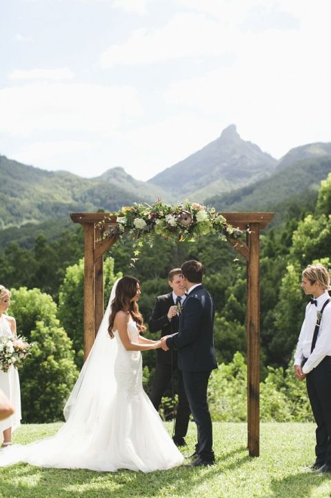 rustic wooden arch decorated with moody florals