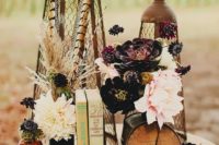 31 a wedding centerpiece with vintage books, an antique clock, stunning peonies and succulents