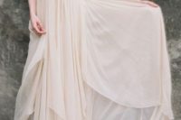 31 flowing peach-colored wedding dress with a deep V-neckline