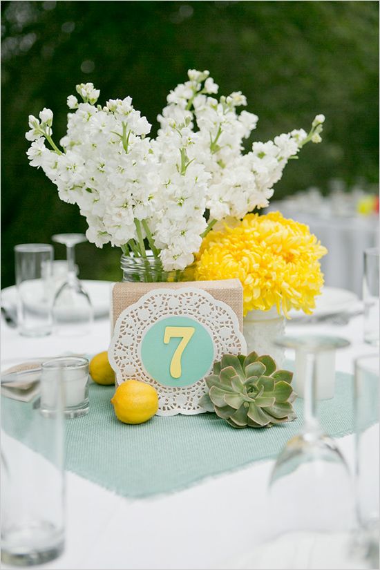 mint fabric and table number on a doily, yellow lemonds and flowers