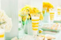 32 yellow flowers, billy balls and glasses, mint dished and a tablecloth