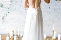 33 bride showing off her backless dress with thin straps