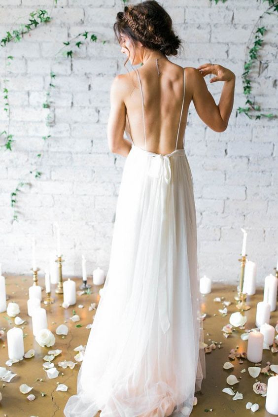 bride showing off her backless dress with thin straps
