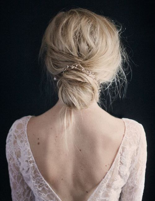 delicate wedding hairstyle with a bun and a crystal hairpiece