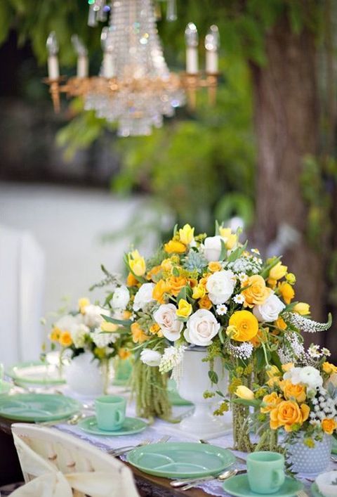 mint dishes and cups, yellow and ivory flowers for centerpieces