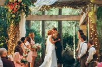 37 wooden wedding arbor decorated with draped fabric, lush florals and lights