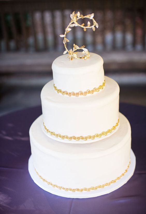 gold leaf cake with a monogram topper