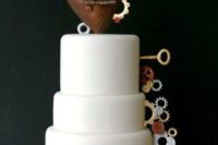 42 plain white wedding cake decorated with gears, a large heart and keys