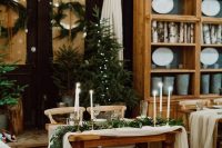 Christmas trees, evergreen runners, wreaths to style a cozy rustic winter wedding or a Christmas one
