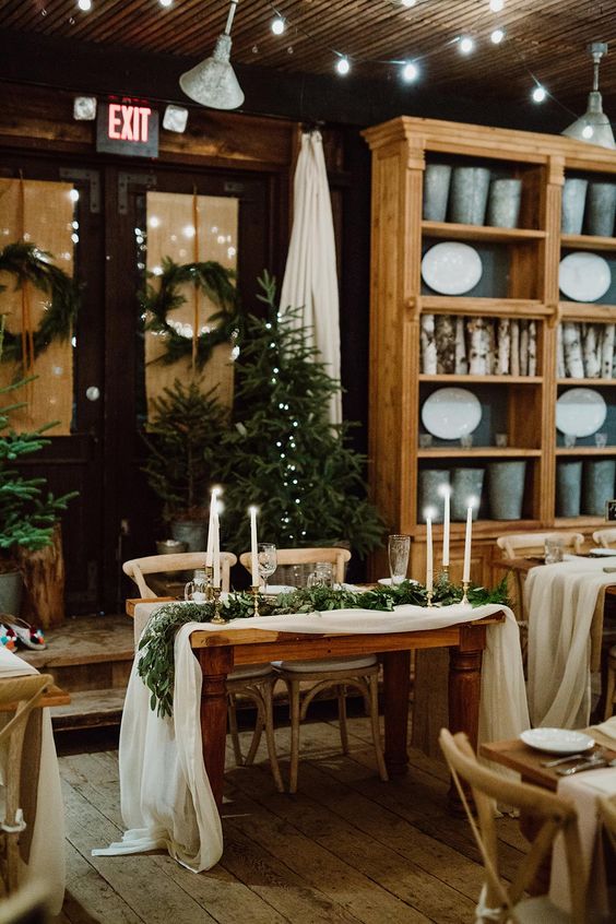 Christmas trees, evergreen runners, wreaths to style a cozy rustic winter wedding or a Christmas one