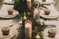 a fir table runner, pinecones, floating and usual candles for a wintery or Christmas wedding table