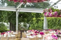 bold pink flower chandelier over the reception to fit the color scheme