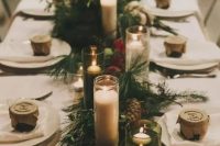 evergreens, pinecones, red leaves and lots of candles for a forest winter wedding