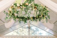 giant greenery and flower chandelier to accentuate the reception space