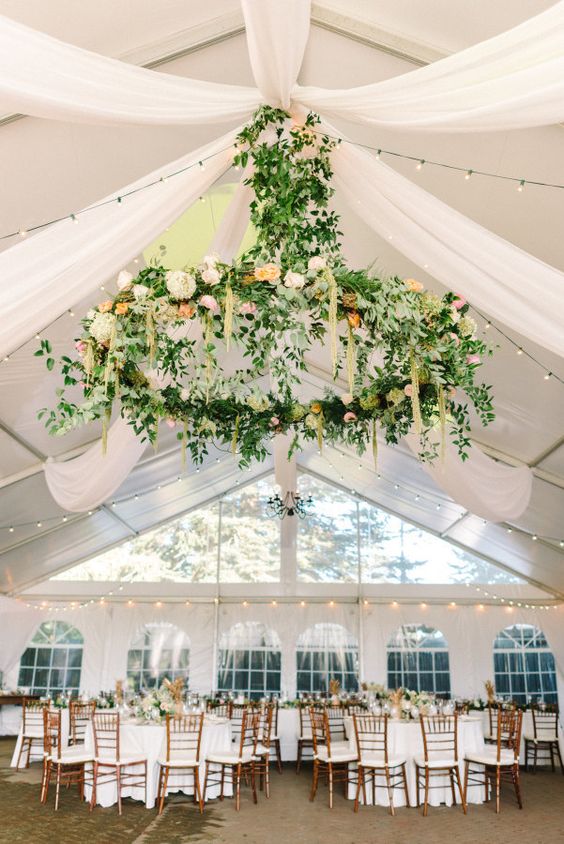 giant greenery and flower chandelier to accentuate the reception space