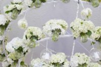 oversized white hydrangea chandelier with flowers in jars to keep them fresh