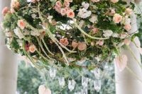 peach-and-pink roses chandelier, hanging candles are suspended below for an extra dash of romance