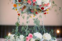 two tier floral chandelier with bold colors and greenery can fir a boho wedding