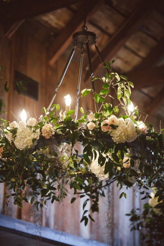 white hydrangea and greenery chandelier with bulbs