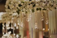white rose hanging chandelier with spheres and candles inside them for a classic wedding