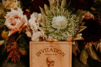 02 Dark moody florals gave the shoot a decadent touch, and the invitations were unique wooden ones