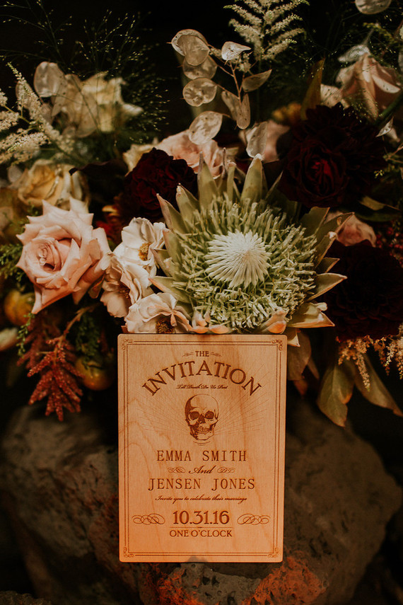 Dark moody florals gave the shoot a decadent touch, and the invitations were unique wooden ones