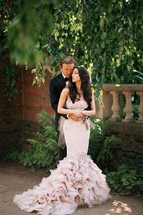 a black tuxedo for the groom and a blush mermaid dress for the bride