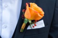 05 the groom rocked a black suti with a copper-colored bow tie and an orange rose