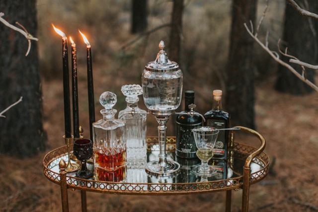 Such an elegant mirror bar cart with black candles is a must for a Halloween wedding