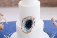 08 all-white cake with a blue geode insert and a gold rim