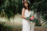 09 A bold pink bridal bouquet with palm leaves echoed with a lush floral crown in pink and red