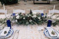 09 The tables were decorated in royal blue, white flowers and eucalyptus