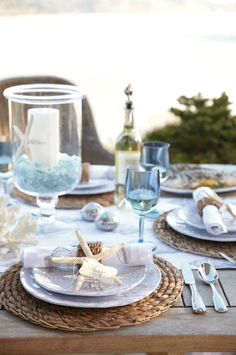 a seaside tablescape with jute placemats and napkin rings