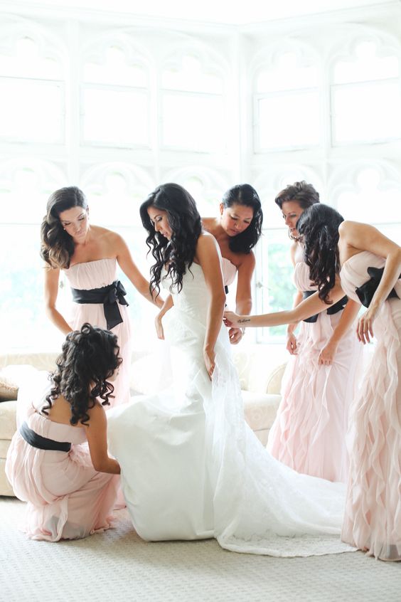 blush ruffled dresses with black sashes and bows
