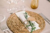 11 jute placemat, a white napkin, a green sprig for an elegant rustic look