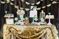 11 mint and gold dessert table with a large sequin tablecloth