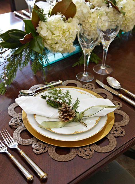 beautiful jute placemat, evergreens, pinecones and neutral flowers