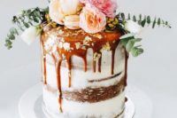 12 dirty frosted wedding cake with caramel drip and lush pastel flowers and greenery